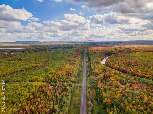 Autumn aerial view of M64 Highway near Bonanza Falls on the Big Iron River -  Looking towards White Pine and Porcupine Mountains Wilderness State Park - Michigan Upper Peninsula   photo