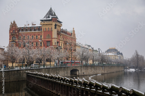 Bellevue house in the style of the Dutch renaissance and Smetana Museum at Smetana embankment, Old town and Vltava river, snow in winter day, Prague, Czech Republic © AnnaRudnitskaya