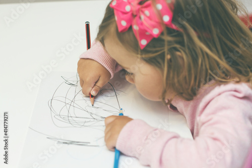 Adorable Creative Little Girl drawing on paper at home. Educational.Child portrait.