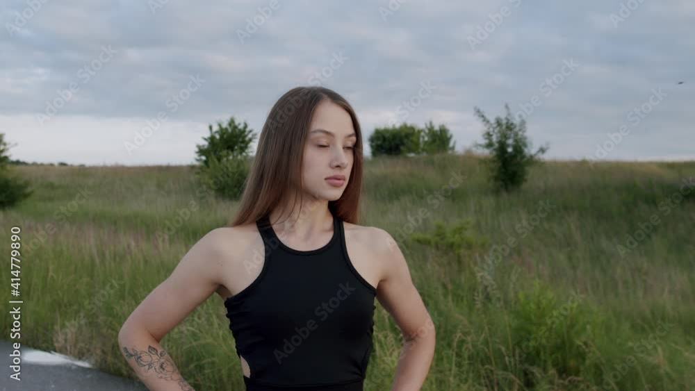 Portrait of beautiful, athletic girl purposefully looking at the camera outdoors Portrait of beautiful, athletic girl purposefully looking at the camera outdoors