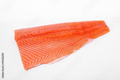 Salmon fillet lies on a light background. View from above.