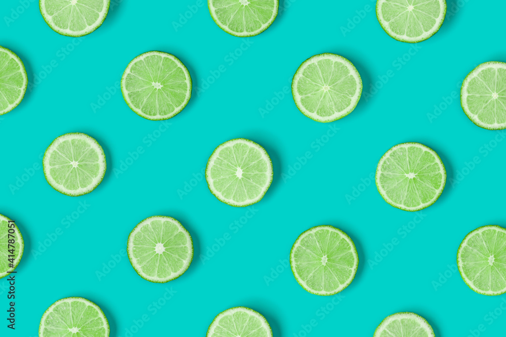 Fruit pattern of lime slices on blue background. Flat lay, top view. . Pop art design, creative summer concept. Fruit pattern of lime slices on blue background. Flat lay, top view. . Pop art design, creative summer concept.