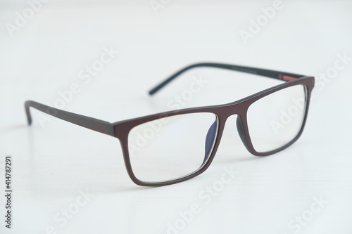 Optical glasses in a dark frame on a white background. Copy, empty space for text