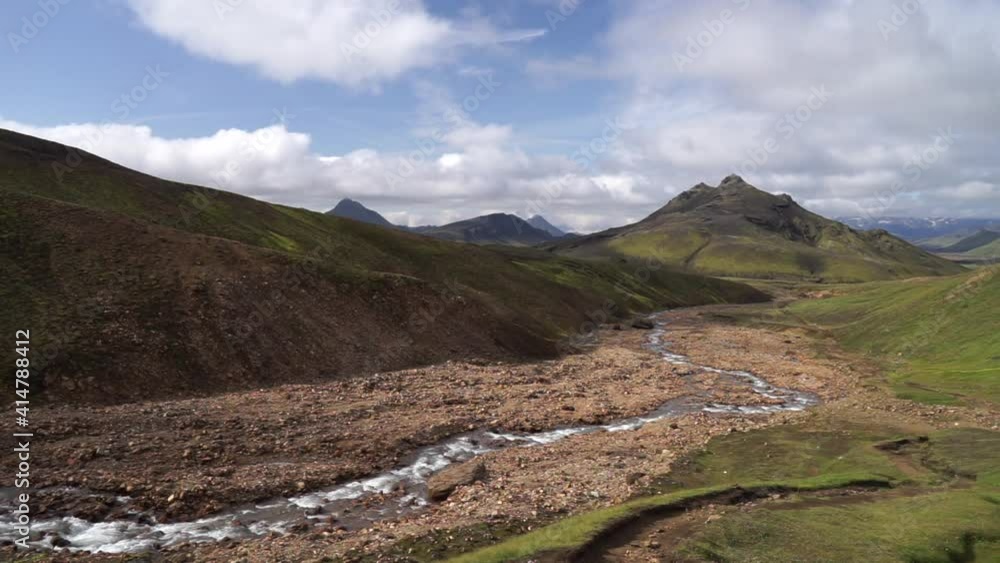 View mountain valley with green hills, river stream and lake. Laugavegur hiking trail, Iceland View mountain valley with green hills, river stream and lake. Laugavegur hiking trail, Iceland
