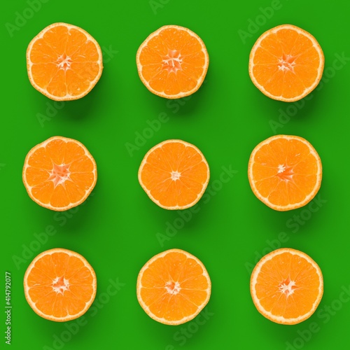 Fruit pattern of fresh orange tangerine or mandarin on green background. Flat lay  top view. Pop art design  creative summer concept. Citrus in minimal style.