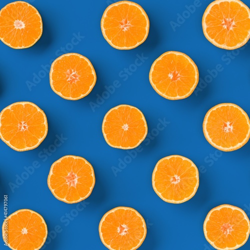 Fruit pattern of fresh orange tangerine or mandarin on blue background. Flat lay  top view. Pop art design  creative summer concept. Citrus in minimal style.
