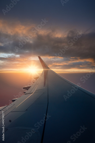 Beautiful view of sunset and clouds from inside window aircraft