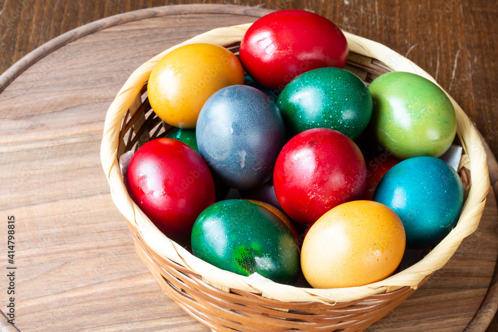 Easter eggs and Easter bun with flowers - wood background Easter eggs and Easter bun with flowers - wood background