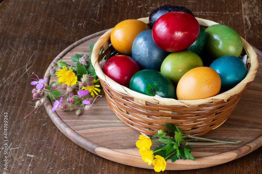 Easter eggs and Easter bun with flowers - wood background Easter eggs and Easter bun with flowers - wood background