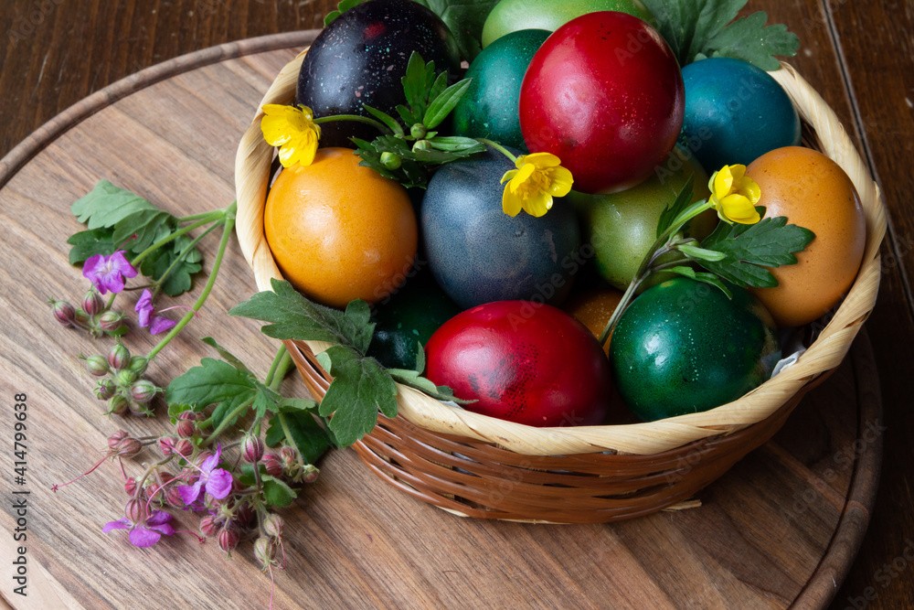 Easter eggs and Easter bun with flowers - wood background Easter eggs and Easter bun with flowers - wood background