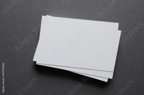 Mock up a stack of blank white cards ün a grey table, space for text or a template