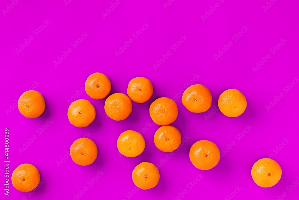 Fruit pattern of fresh orange tangerine or mandarin on lilac background. Flat lay, top view. Pop art design, creative summer concept. Citrus in minimal style. Fruit pattern of fresh orange tangerine or mandarin on lilac background. Flat lay, top view. Pop art design, creative summer concept. Citrus in minimal style.