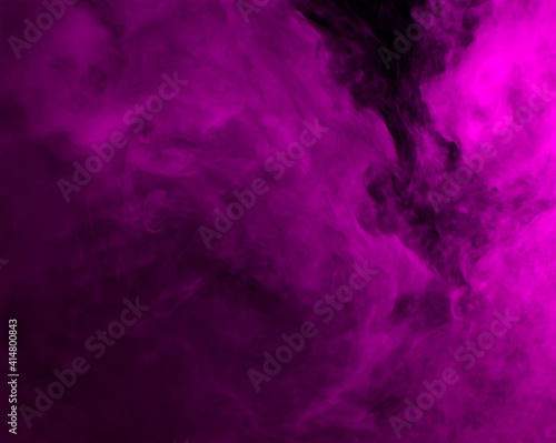 Abstract background of chaotically mixing puffs of purple smoke on a dark background