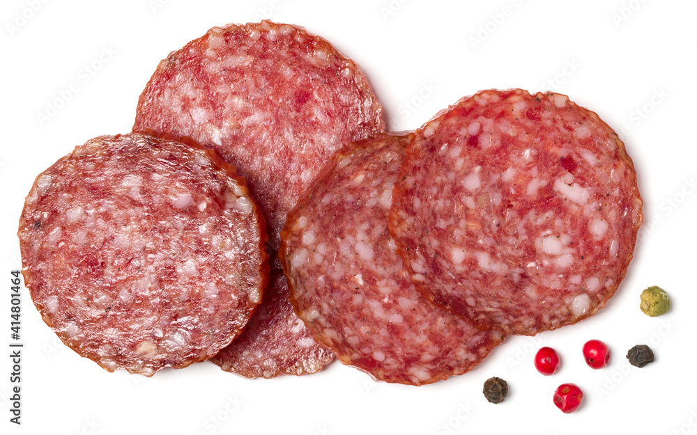 Slices of salami isolated on white background closeup. Sausage top view. Slices of salami isolated on white background closeup. Sausage top view.