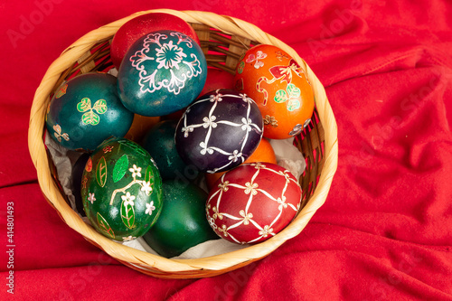 Easter eggs and Easter bun with flowers - red background photo