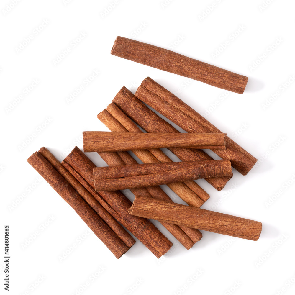 Cinnamon sticks isolated on white background closeup. Canella spice. Aromatic condiment background. Flat lay, top view. Cinnamon sticks isolated on white background closeup. Canella spice. Aromatic condiment background. Flat lay, top view.