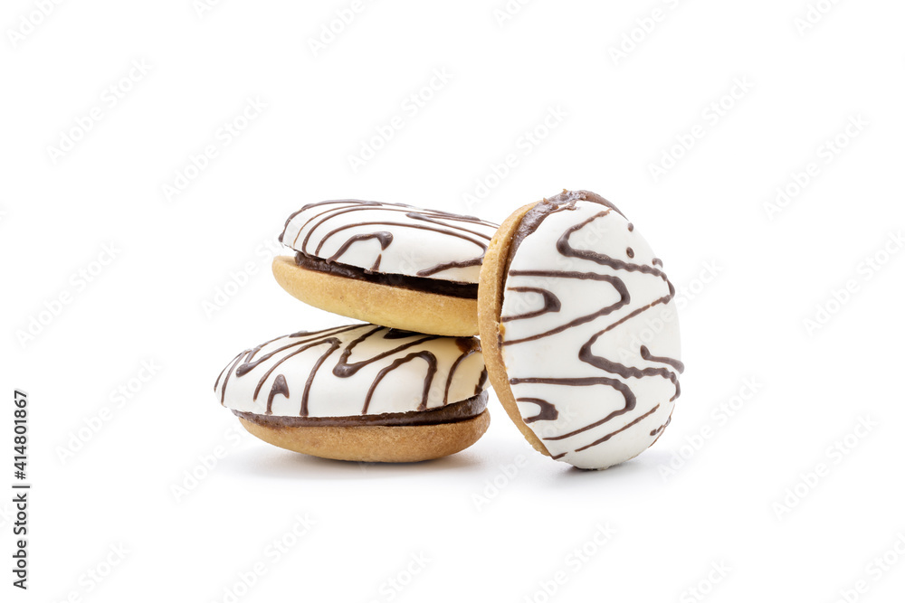 Fototapeta premium cookie with white icing and chocolate rows isolated on white background. sweet cake cut out