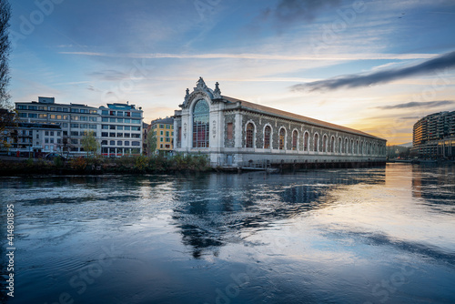Batiment des Forces Motrice Power Plant Building and Rhone River at sunset - Geneva, Switzerland .