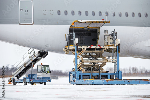 Preparing the aircraft before flight. Loading of baggage. Loading of cargo. Loading platform of air freight to the aircraft.