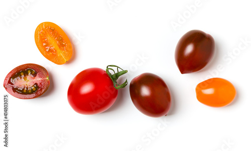 various colorful tomatoes isolated on white background. Top view, flat lay. Creative layout.
