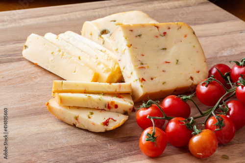 Soft cheese with olives and cheese with chili peppers with tomatoes and rosemary – wood