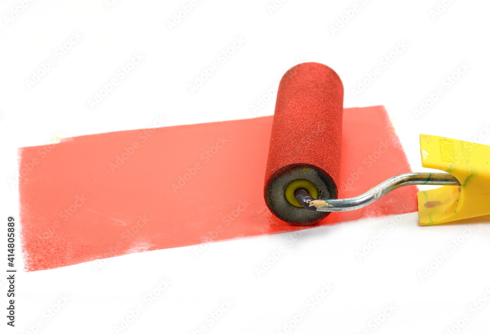 Obraz premium Paint roller leaving stroke of red color over a white background. usable for text and messages.