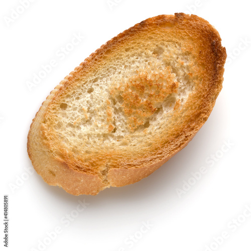 Toasted baguette slice isolated on white background close up. Toast, crouton. Top view.
