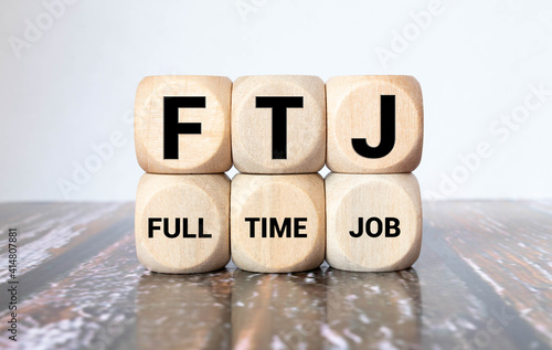 Cubes or dice with acronym FTJ for Full Time Job photo