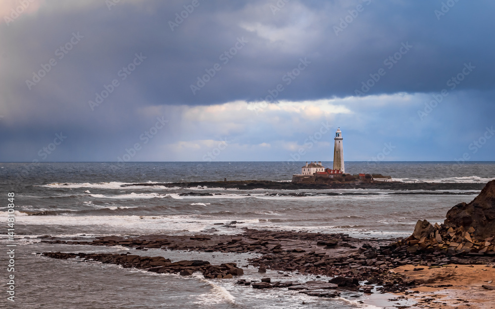 St Mary's Lighthouse on the tiny island, just north of Whitley Bay on the coast of North East England. Cold winter cloudy day. Northumberland, UK.