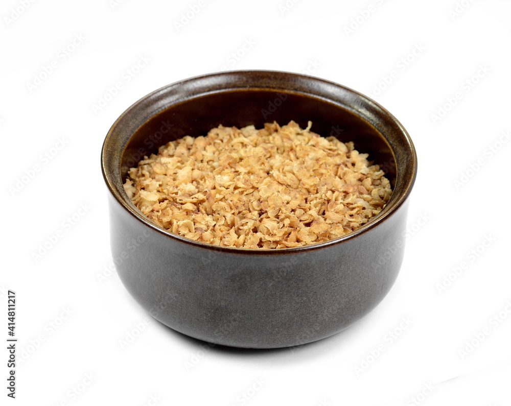 Buckwheat flakes in a bowl isolated on white background. Healthy buckwheat flakes. Healthy food. Buckwheat flakes in a bowl isolated on white background. Healthy buckwheat flakes. Healthy food.