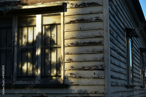 exterior corner of old wooden house, queenslander-style, casement windows   photo