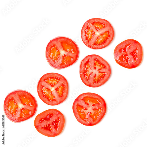 Creative layout made of tomato slices. Flat lay, top view. Food concept. Vegetables isolated on white background. Food ingredients pattern.