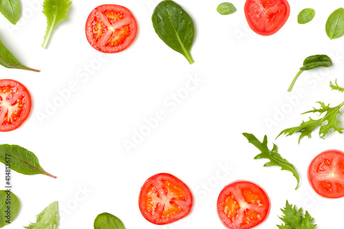 Creative layout made of tomato slices and lettuce salad leaves. Flat lay, top view. Food concept. Vegetables isolated on white background. Food ingredients pattern with copy space.