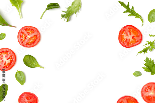 Creative layout made of tomato slices and lettuce salad leaves. Flat lay  top view. Food concept. Vegetables isolated on white background. Food ingredients pattern with copy space.