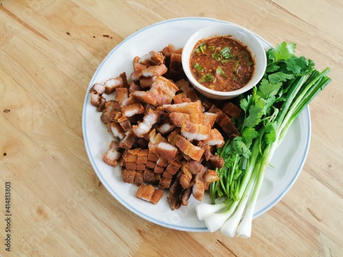 Fried pork belly with fish sauce in a plate
