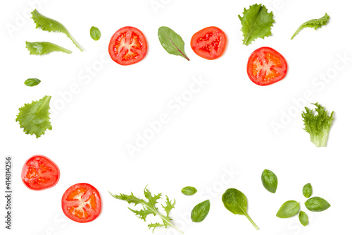 Creative layout made of tomato slices and lettuce salad leaves. Flat lay, top view. Food concept. Vegetables isolated on white background. Food ingredients pattern with copy space.