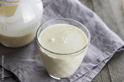 Selective focus to top view of glass with fermented baked milk.