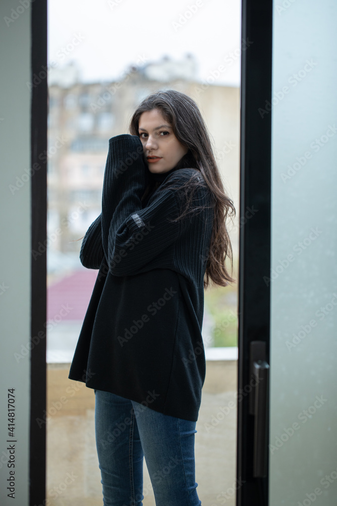 Pretty girl in black sweater posing on terrace Pretty girl in black sweater posing on terrace