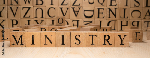 The word ministry is from wooden cubes. Economy state government terms. Closeup.