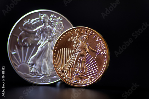 A gold and silver coin on black background