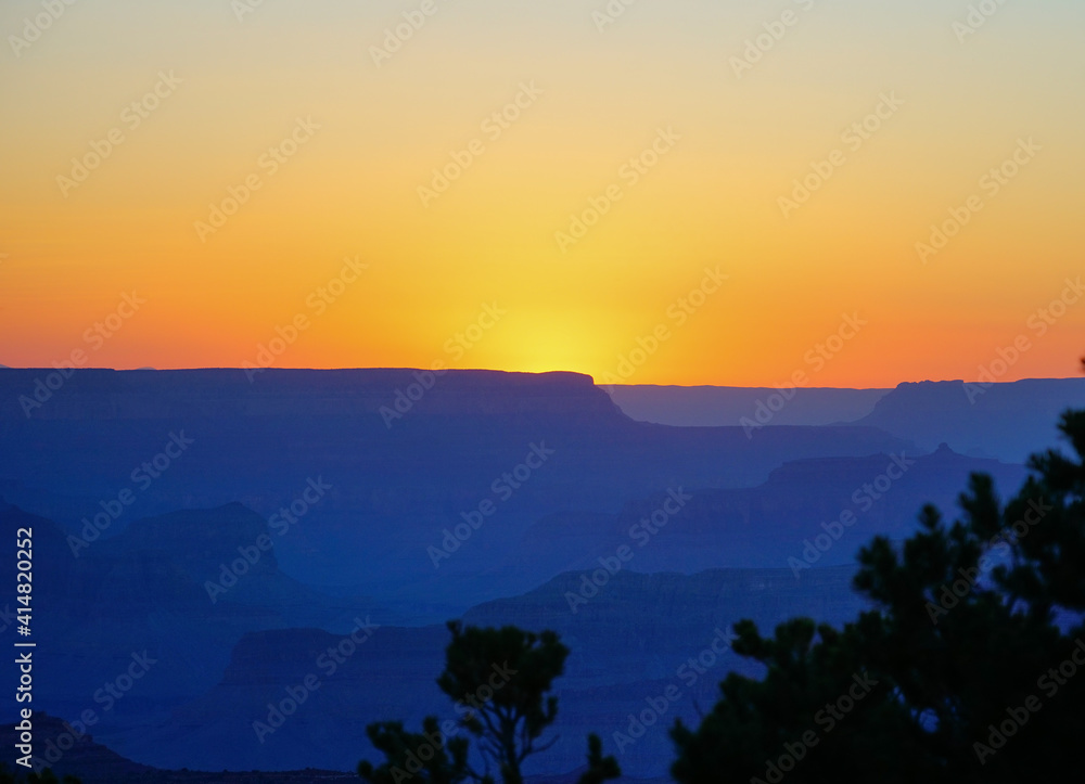 Golden Sunset at Grand Canyon Arizona. Blue smoky haze accentuates the canyon.