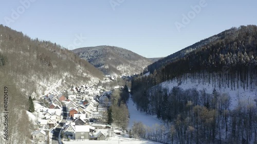 Aerial footage of the harz after a heavy snow storm in the winter of 2021. The Harz is a german national Park in with beautiful mountain landscapes in central Germany, Europe. photo