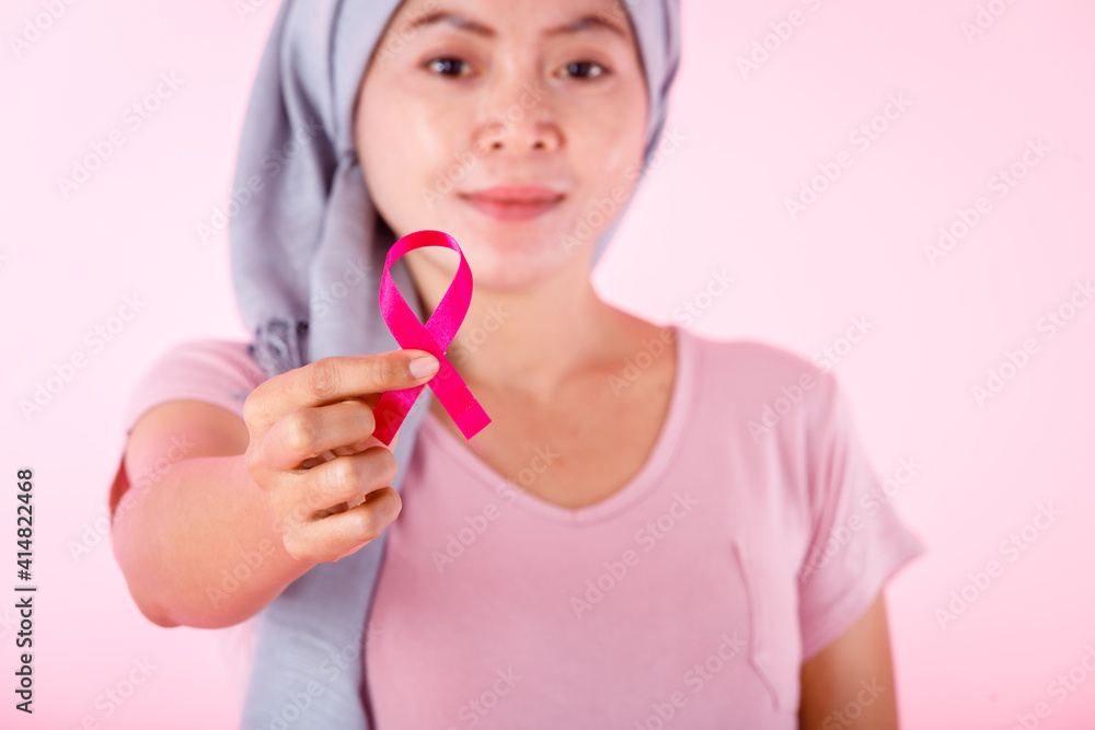 a asian women disease mammary cancer patient in pullover holding pink ribbon isolated on pink blank copy space studio background,healthcare,medicine concept a asian women disease mammary cancer patient in pullover holding pink ribbon isolated on pink blank copy space studio background,healthcare,medicine concept