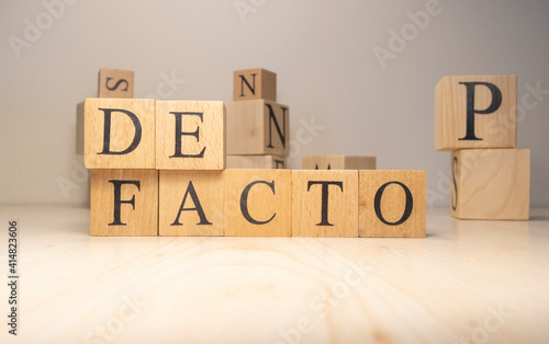 The Defacto Word is from wooden cubes. Terms of state government.