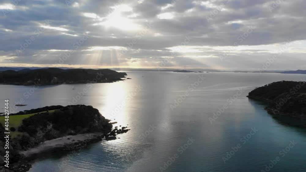drone flying above Urupukapuka Island with the sunlight leaks in a distance