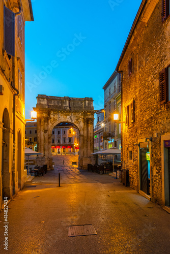 Sunrise view of Arch of the Sergii at Croatian town Pula photo