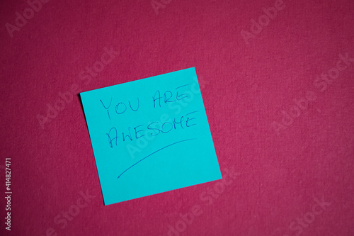 A card with handwritten text "you are awesome".