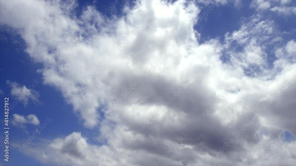 Time Lapse: White fluffy clouds moving across blue sky Time Lapse: White fluffy clouds moving across blue sky