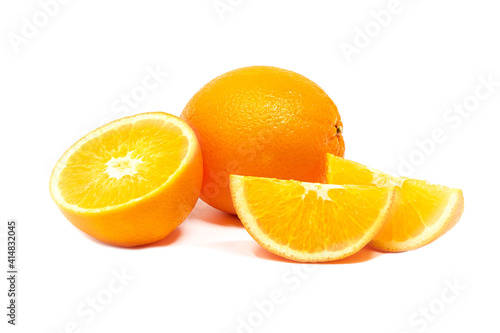Slieced and whole fresh tropical oranges on white background