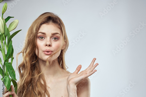 girl with flowers cropped view portrait close-up spring bare shoulders clear skin Make Up